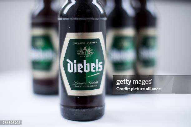 Diebels beer bottles standing on a kitchen table in Recklinghausen, Germany, 16 January 2018. Two traditional German beer brands are changin their...