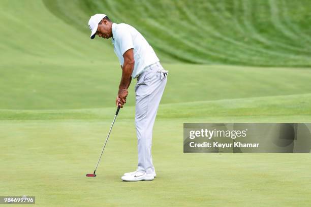 Tiger Woods tests a TaylorMade Ardmore 3 mallet putter on the 15th hole during practice for the Quicken Loans National at TPC Potomac at Avenel Farm...
