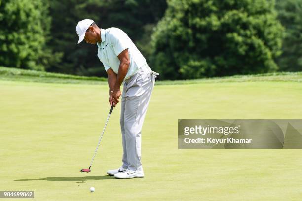 Tiger Woods tests a TaylorMade Ardmore 3 mallet putter on the 16th hole during practice for the Quicken Loans National at TPC Potomac at Avenel Farm...