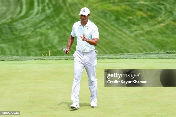 Tiger Woods uses a TaylorMade Ardmore 3 mallet putter to grab his ball on the 16th hole during practice for the Quicken Loans National at TPC Potomac...