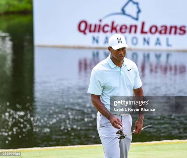 Tiger Woods tests a TaylorMade Ardmore 3 mallet putter on the 17th hole during practice for the Quicken Loans National at TPC Potomac at Avenel Farm...