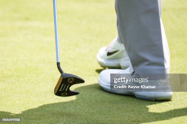 Detail shot as Tiger Woods tests a TaylorMade Ardmore 3 mallet putter on the 17th hole during practice for the Quicken Loans National at TPC Potomac...