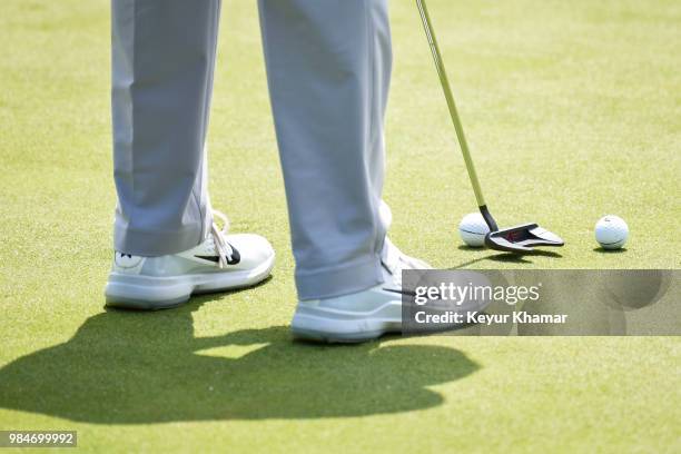 Detail shot as Tiger Woods tests a TaylorMade Ardmore 3 mallet putter on the 17th hole during practice for the Quicken Loans National at TPC Potomac...