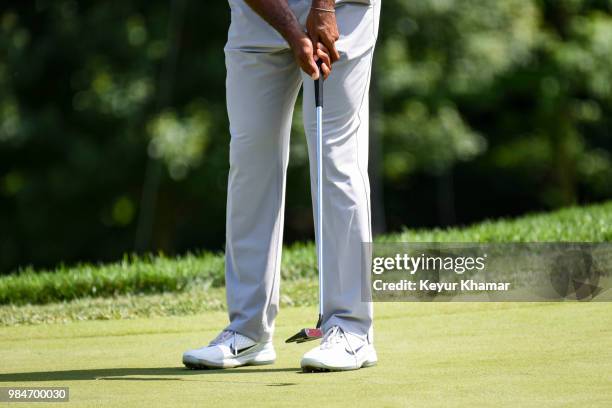 Detail shot as Tiger Woods tests a TaylorMade Ardmore 3 mallet putter on the 18th hole during practice for the Quicken Loans National at TPC Potomac...