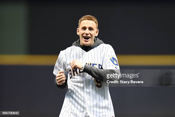 Milwaukee Bucks first round draft pick Donte DiVincenzo throws out the first pitch prior to a game between the Milwaukee Brewers and the Kansas City...