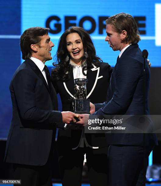 Vegas Golden Knights President of Hockey Operations and general manager George McPhee accepts the NHL General Manager of the Year Award from actress...