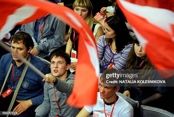 Members of the pro-Kremlin youth group Nashi wave their flags during their fifth congress in Moscow on April 15, 2010. AFP PHOTO / NATALIA KOLESNIKOVA