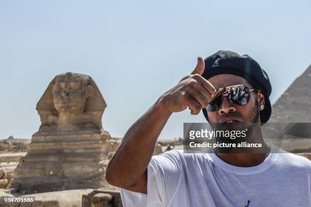 Dpatop - FILE - Brazilian former soccer player Ronaldinho gestures during a visit to the Pyramids of Giza in Giza, Egypt, 05 July 2017. On 16 January...