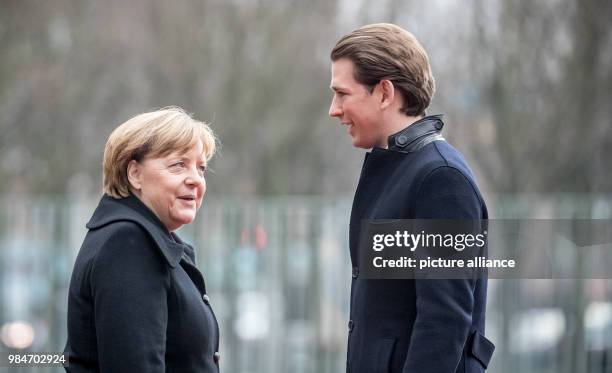 German Chancellor Angela Merkel speaks with Austrian Chancellor Sebastian Kurz, during his reception at the German Chancellery in Berlin, Germany, 17...