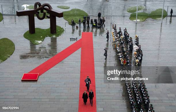 German Chancellor Angela Merkel and Austrian Chancellor Sebastian Kurz, inspect the guard of honour during his reception at the German Chancellery in...