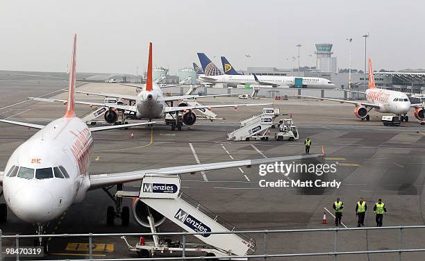 Ground staff walk away from a grounded aircraft at Bristol Airport on April 15, 2010 in Bristol, England. All flights in and out of Britain's...