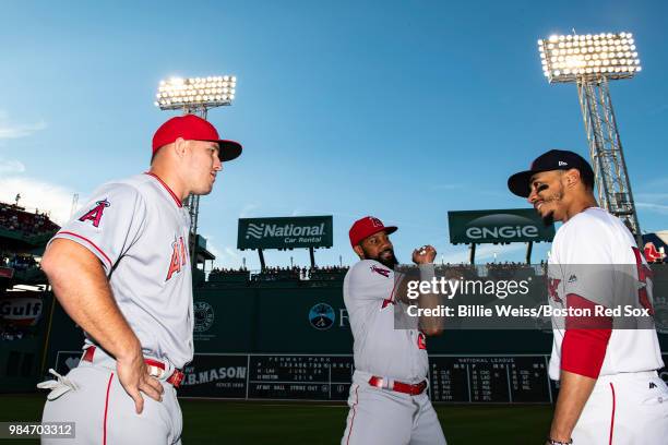 Mike Trout and Chris Young of the Los Angeles Angels of Anaheim talk with Mookie Betts of the Boston Red Sox before a game on June 26, 2018 at Fenway...