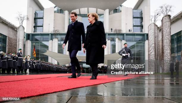 German Chancellor Angela Merkel and Austrian Chancellor Sebastian Kurz, inspect the guard of honour during his reception at the German Chancellery in...