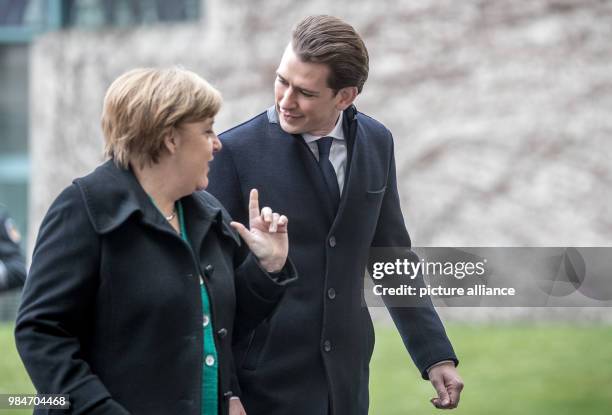 Dpatop - German Chancellor Angela Merkel walks next to Austrian Chancellor Sebastian Kurz, upon his arrival to the German Chancellery in Berlin,...