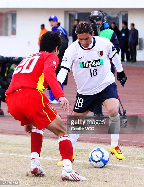 Baofeng Zhang of China Changchun Yatai fights for a ball against Marcos Gomes De Araujo Marquinhos of Kashima Antlers during the AFC Champions League...