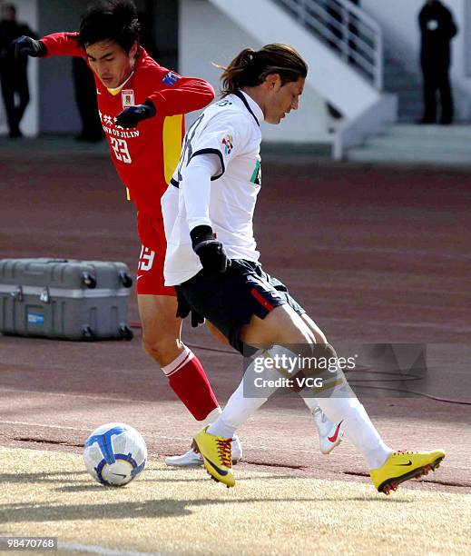 Xiaofei Zhang of China Changchun Yatai competes for the ball with Marcos Gomes De Araujo Marquinhos of Kashima Antlers during the AFC Champions...