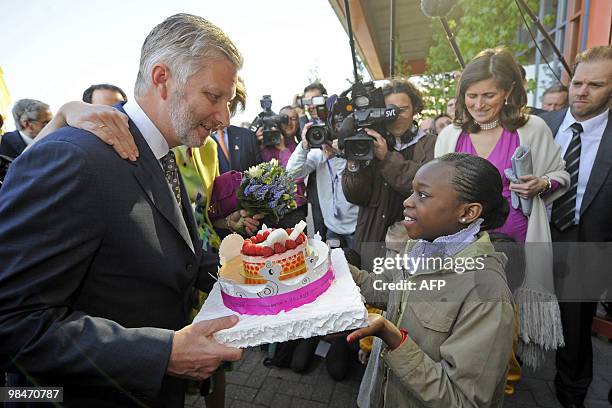 Belgium's Crown Prince Philippe receives a birthday cake for his 50th birthday on April 15, 2010 during a visit to the Floralies of Ghent 2010 in the...