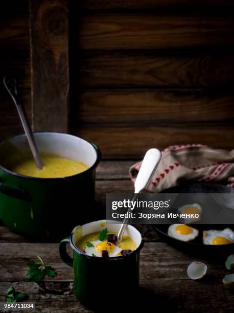 potato soup - mashed potatoes with fried eggs on a rustic background in vintage style. - mashed stock pictures, royalty-free photos & images