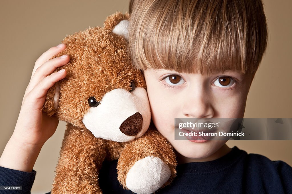 Child Cheek To Cheek With Teddy Bear