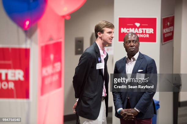 Bo Hart, left, and Travis Worthy wait for results at a Republican gubernatorial primary runoff election watch party at Spirit Communications Park on...