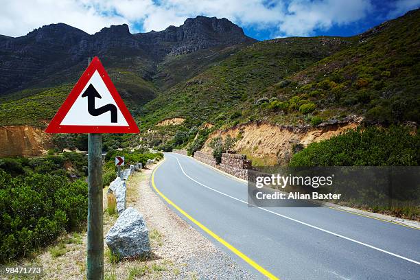 view of road with sign - chapmans peak stock pictures, royalty-free photos & images