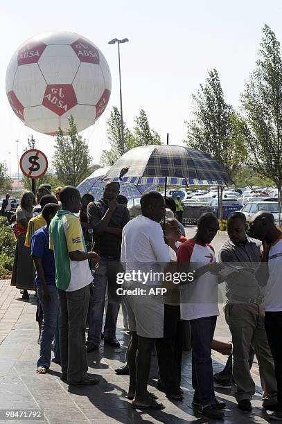 People queue to purchase official 2010 FIFA World Cup tickets on April 15, 2010 at the Maponya shopping mall in Soweto during the first day of the...