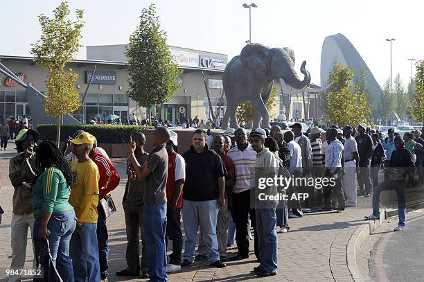 People queue to purchase official 2010 FIFA World Cup tickets on April 15, 2010 at the Maponya shopping mall in Soweto on the first day of the...