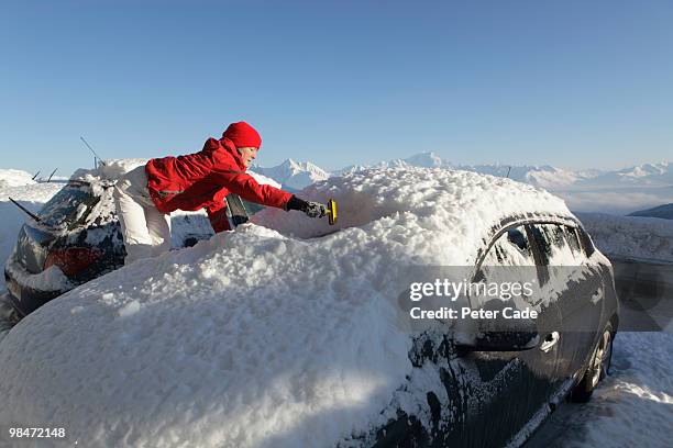 woman scraping thick snow off of car - peter snow stock pictures, royalty-free photos & images