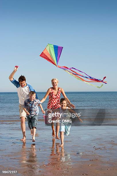 family with kite on beach - northumberland foto e immagini stock