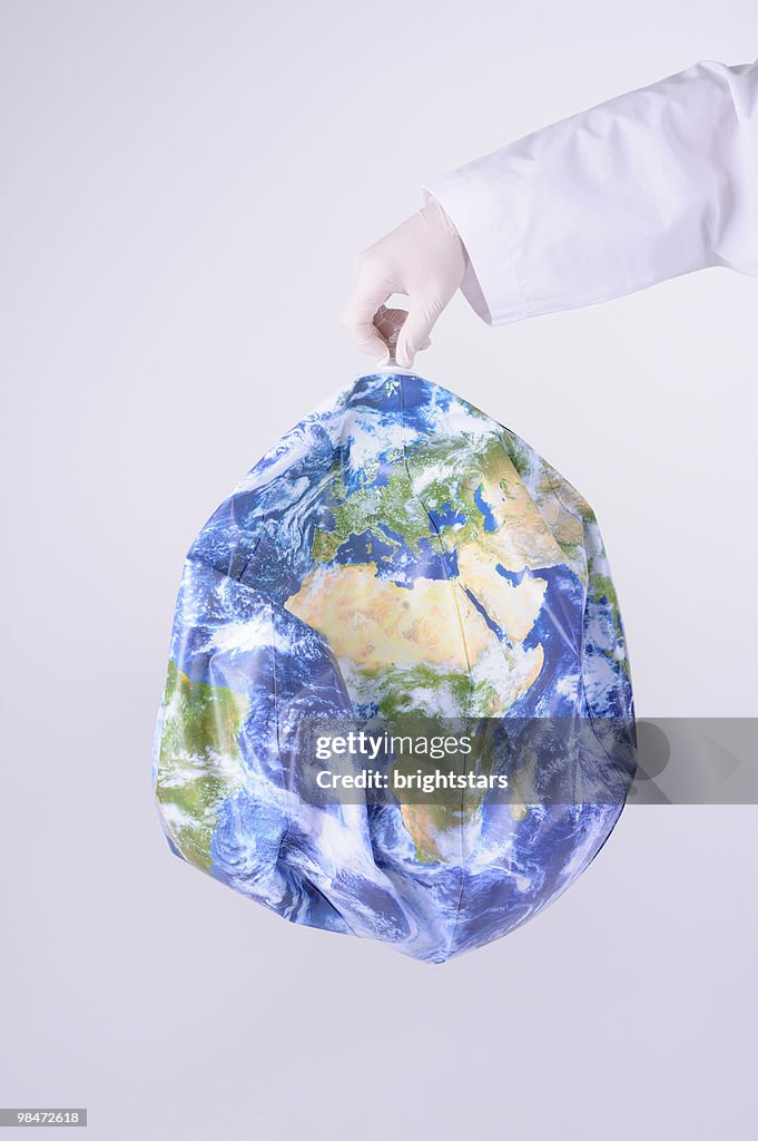 Hand holding inflatable earth ball