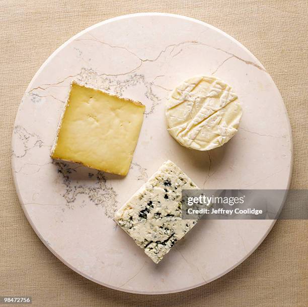 three cheeses on stone - jeffrey coolidge stock-fotos und bilder