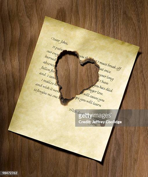heart burned into 'dear john' letter - jeffrey coolidge stock-fotos und bilder