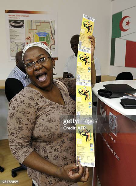 Woman shows official 2010 FIFA World Cup tickets she just purchased on April 15, 2010 at the Maponya shopping mall in Soweto during the first day of...