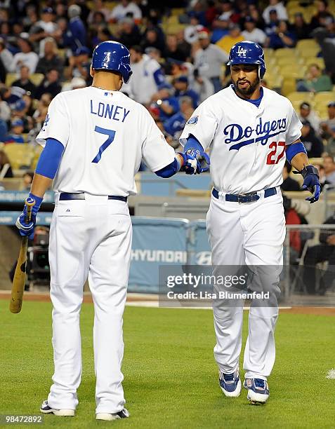 Matt Kemp celebrates with teammate James Loney of the Los Angeles Dodgers after scoring in the first inning against the Arizona Diamondbacks at...