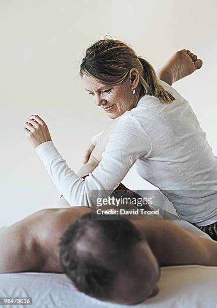 woman giving healing massage. - david trood stockfoto's en -beelden