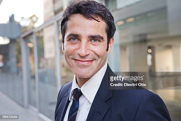portrait of smiling businessman - mid adult men stock pictures, royalty-free photos & images
