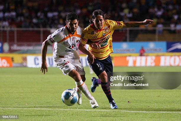 Jaguares's player Javier Marcelo vies for the ball with Hugo Droguett of Morelia during their match as part of the 2010 Bicentenary Tournament in the...