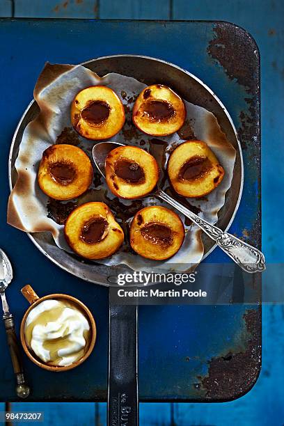 baked nectarines with honey in frying pan - martin poole stock pictures, royalty-free photos & images