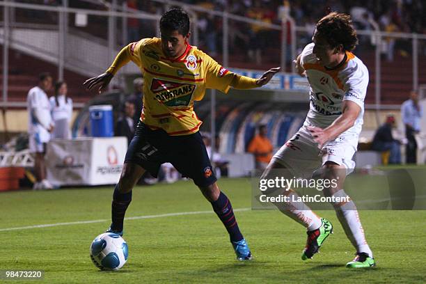 Morelia's player Elias Hernandez vies for the ball with Diego Ordaz of Jaguares during their match as part of the 2010 Bicentenary Tournament in the...