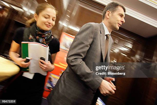 Mikhail Prokhorov, president of Onexim Group MGMT Ltd, right, leaves after the congress of Russian Union of Industrialists and Entrepreneurs in...