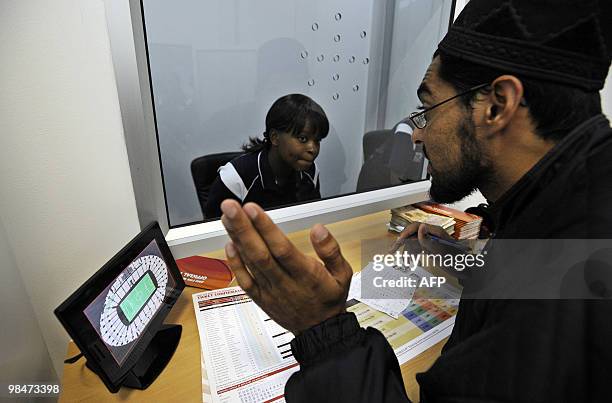 Man chooses for seats on a screen as he purchases official 2010 FIFA World Cup tickets at a booking office on April 15, 2010 at the Maponya shopping...