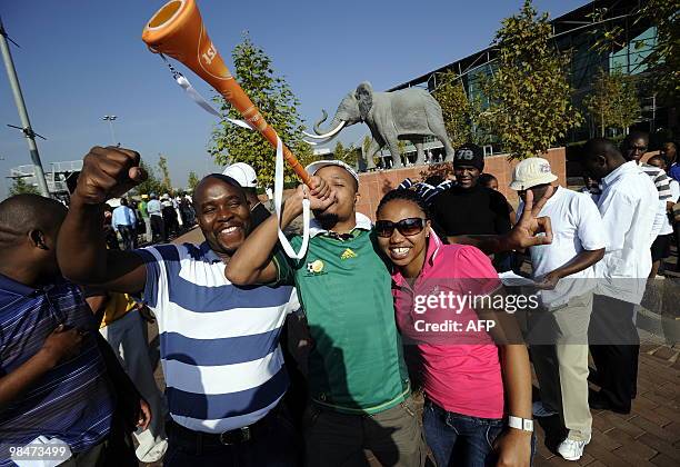 Man blows a Vuvuzela as he queues along with others to purchase official 2010 FIFA World Cup tickets on April 15, 2010 at the Maponya shopping mall...