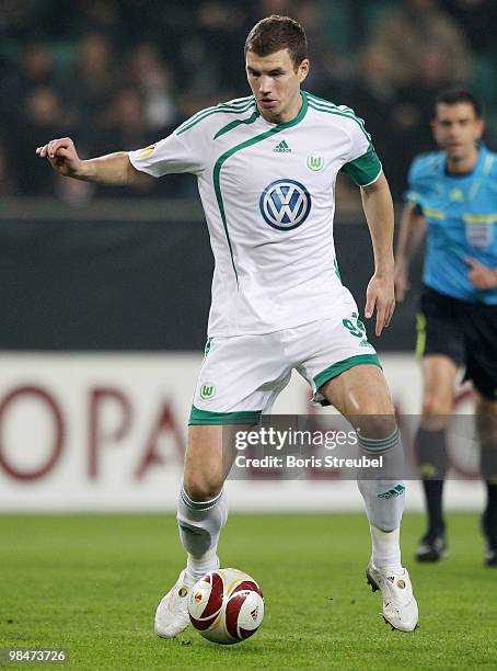 Edin Dzeko of Wolfsburg runs with the ball during the UEFA Europa League quarter final second leg match between VfL Wolfsburg and Fulham FC at...