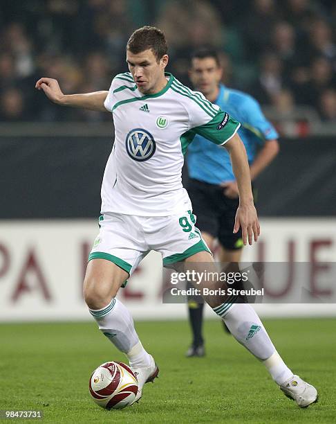 Edin Dzeko of Wolfsburg runs with the ball during the UEFA Europa League quarter final second leg match between VfL Wolfsburg and Fulham FC at...