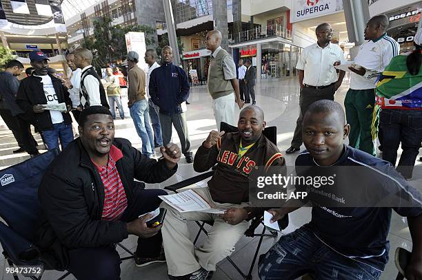 People chat on their chairs as they queue to purchase official 2010 FIFA World Cup tickets on April 15, 2010 at the Maponya shopping mall in Soweto...