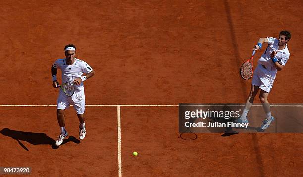 Ross Hutchins and Andy Murray of Great Britain in action in their doubles match against Bob Bryan and Mike Bryan of USA during day four of the ATP...