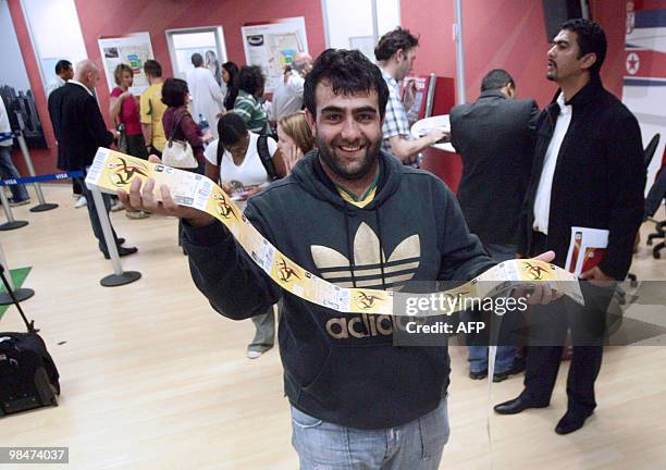 Man shows official 2010 FIFA World Cup tickets he just purchased on April 15, 2010 at the Maponya shopping mall in Soweto during the first day of the...