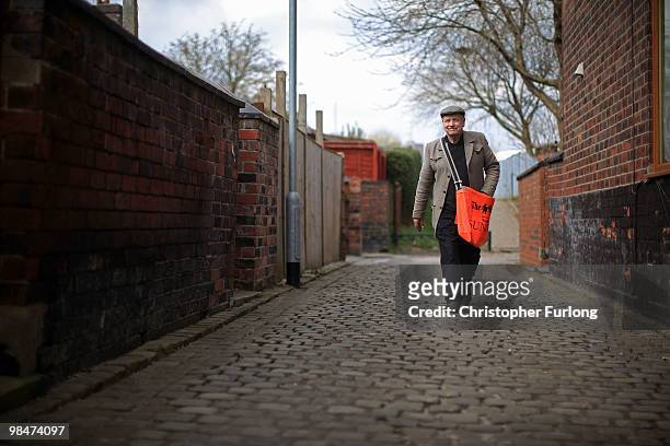 Newspaper delivery man Terry Manley does his round on the streets of Stoke, Terry is undecided who he will vote for in the general election, April...