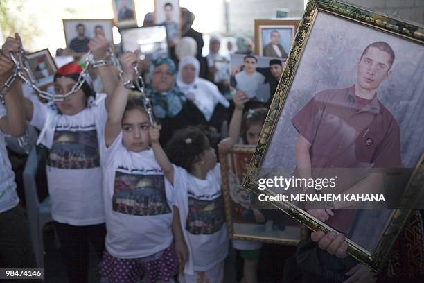 Palestinian girls symbolically chain their hands during a protest in east Jerusalem on April 15, 2010 to demand the release of Palestinian prisonders...