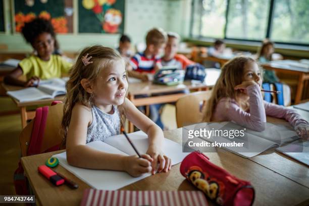 elementary students paying attention during a class in the classroom. - elementary school building stock pictures, royalty-free photos & images